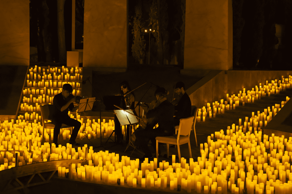 A string quartet performing at an open-air Candlelight concert