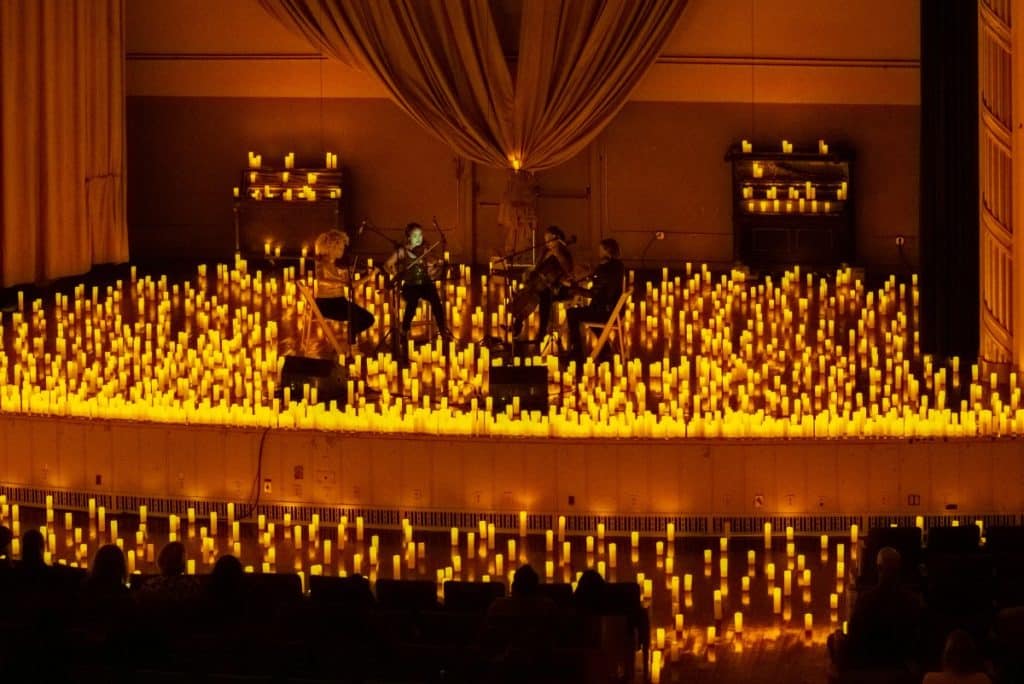 The stage of BOK Auditorium filled with candles