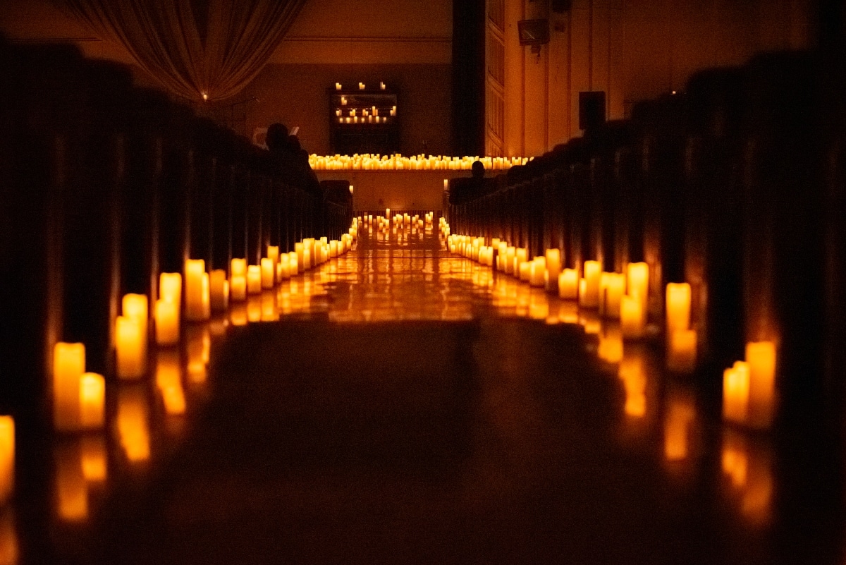 aisle of bok auditorium in philadelphia lit up by candles in preparation for candlelight concert