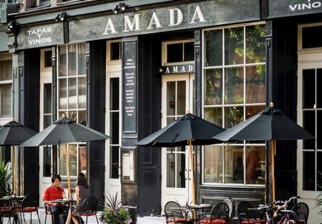 Exteriors with customers eating outside at Amada in Philadelphia